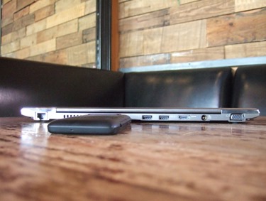 5 picture of closed laptop with a small black device next to it