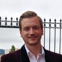 George Hackford, a man in a business suit and light hair smiling at the camera.