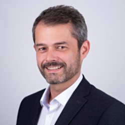 Craig Wellman, a man wearing a suit and tie smiling at the camera