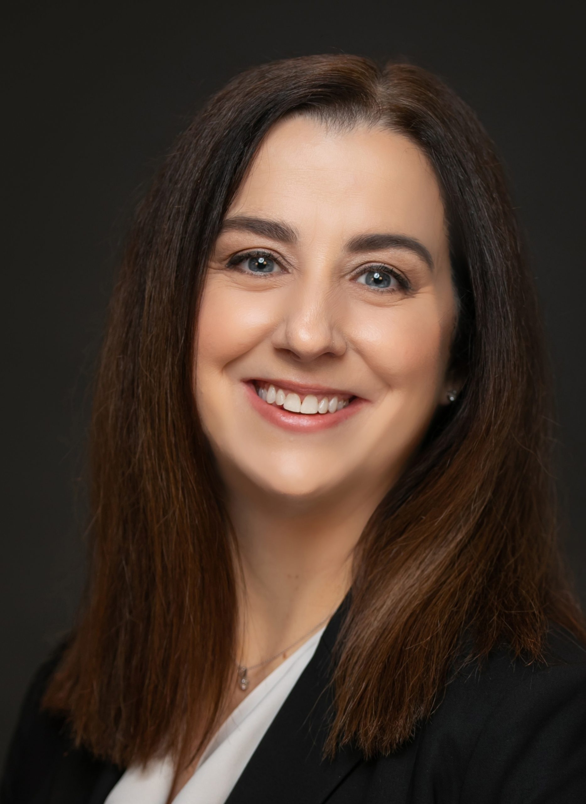 Robin Sutara, a woman with dark brown long hair smiles at the camera