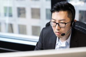 Man talking on a headset in an office