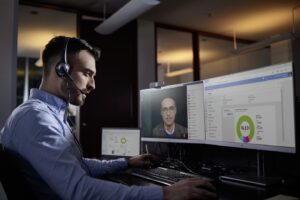 Man works at multiple PC screens