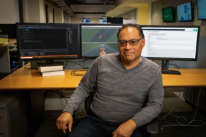 a man sitting at a desk in front of a computer