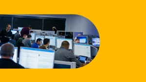 A team of security practitioners work at desks.