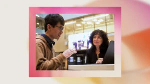 A man and woman looking at a laptop