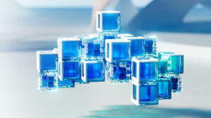 Blue cubes on a glass-like surface that produces a reflection.