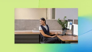 A woman sitting at a desk with a computer