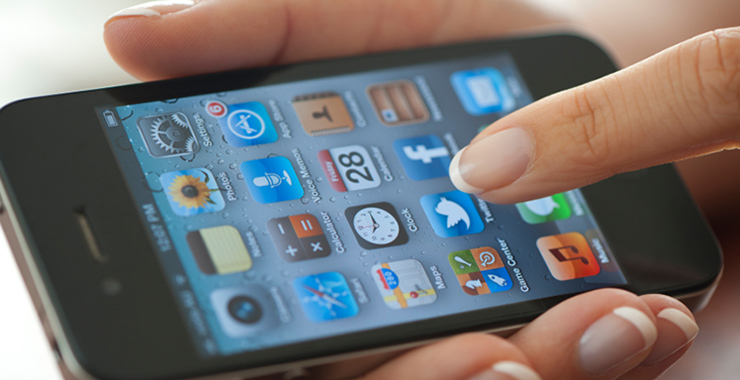 a hand holding a remote control