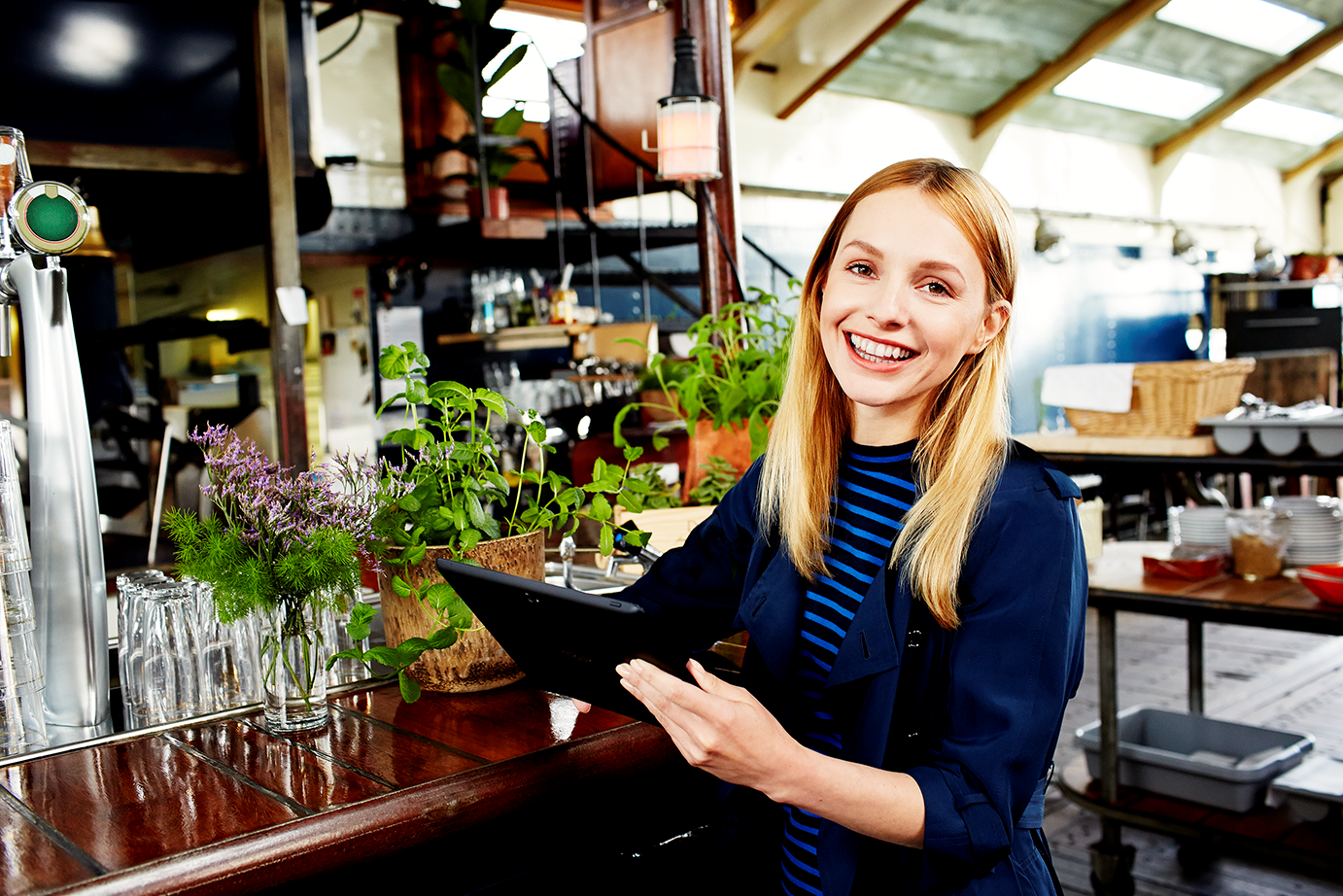 a woman sitting at a table and smiling at the camera