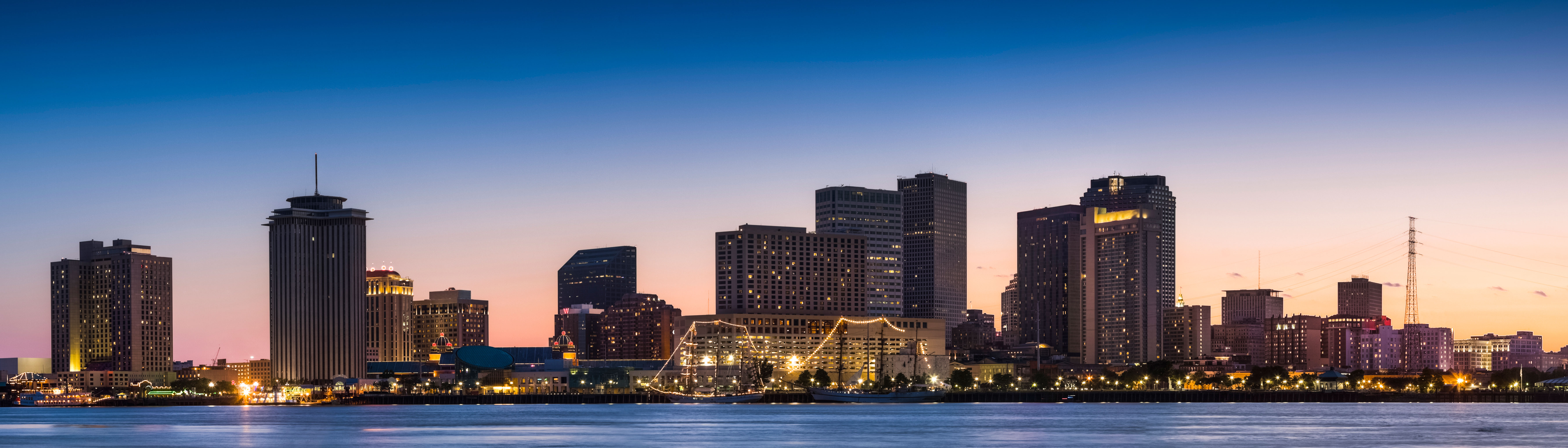 a large body of water with a city in the background