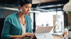 a person standing in front of a laptop