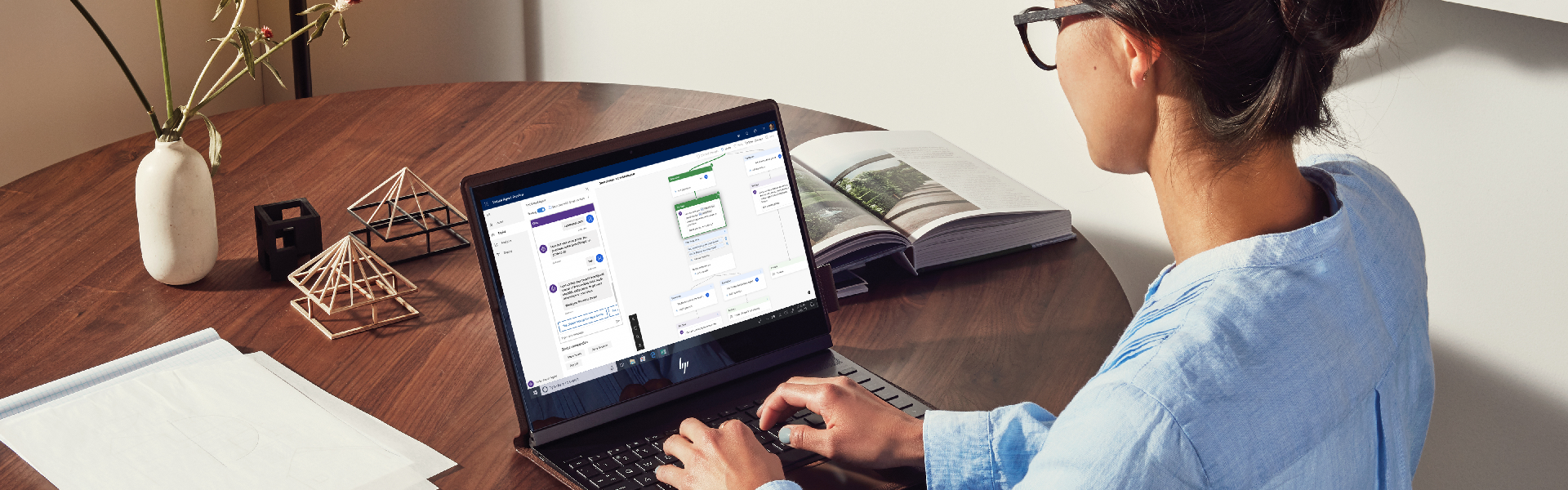 a person sitting at a table using a laptop