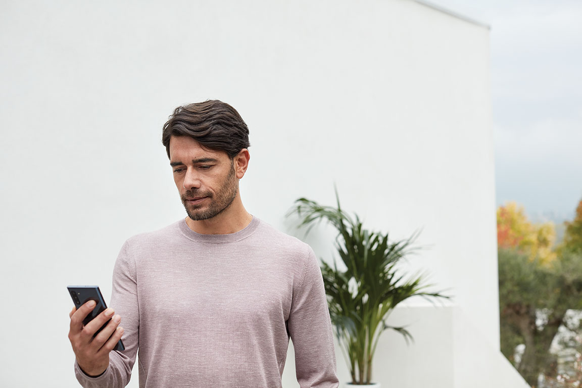 Adult outside home on phone. Back to school. Samsung Galaxy Note 10