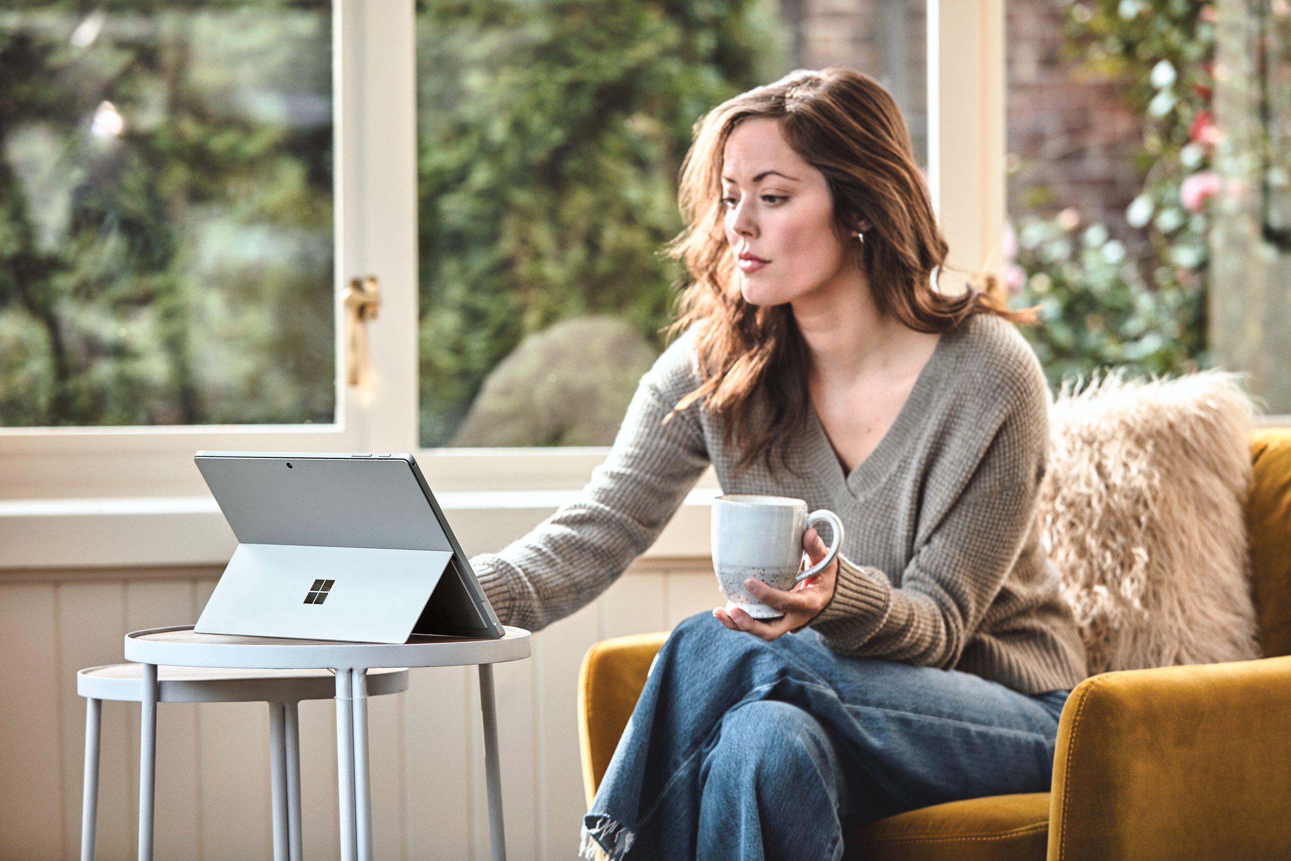 Woman interacting with a Surface Pro laptop.