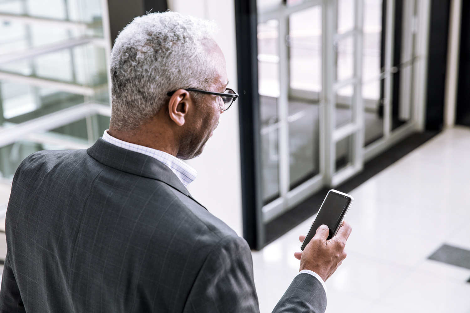 Man holding mobile phone in office