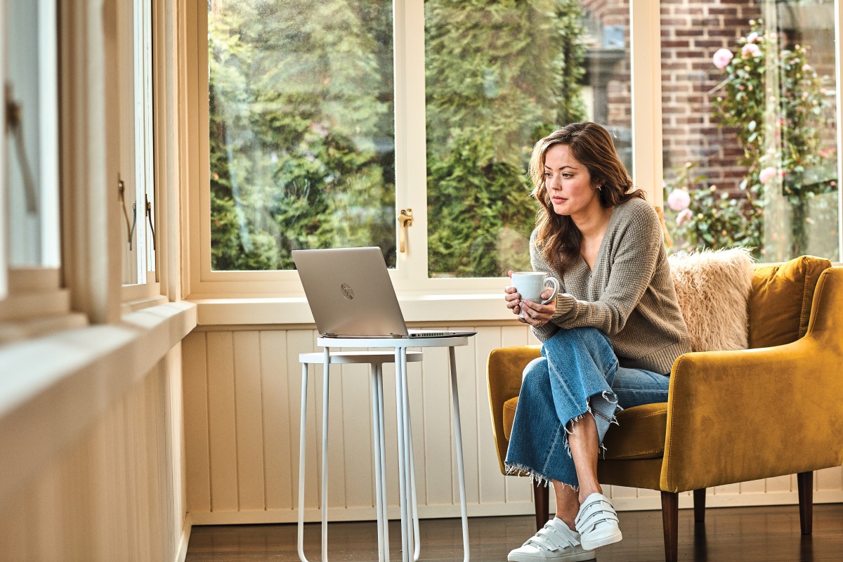a woman sitting on a chair in front of a window