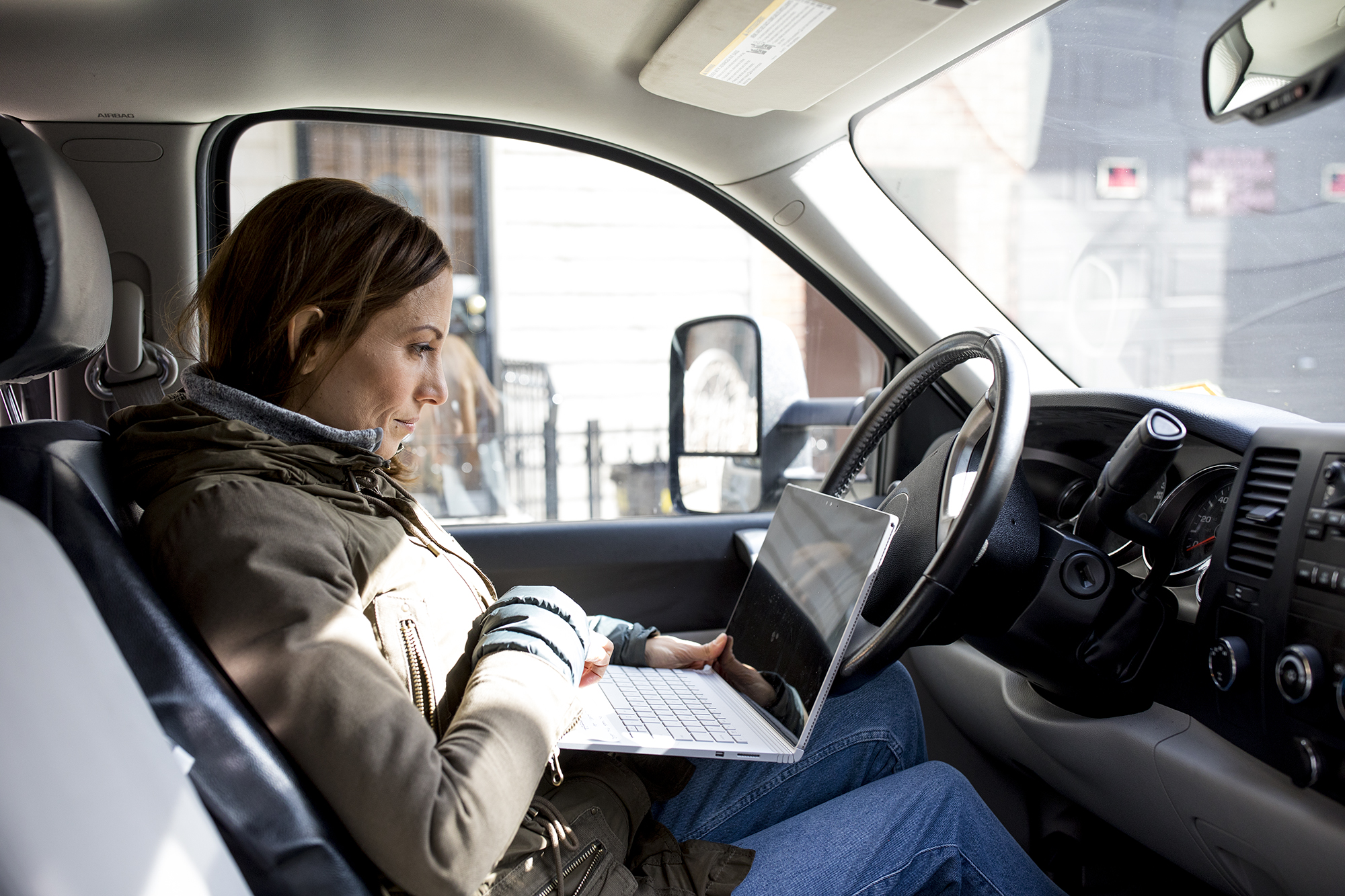 Worker sitting on the seat of a car