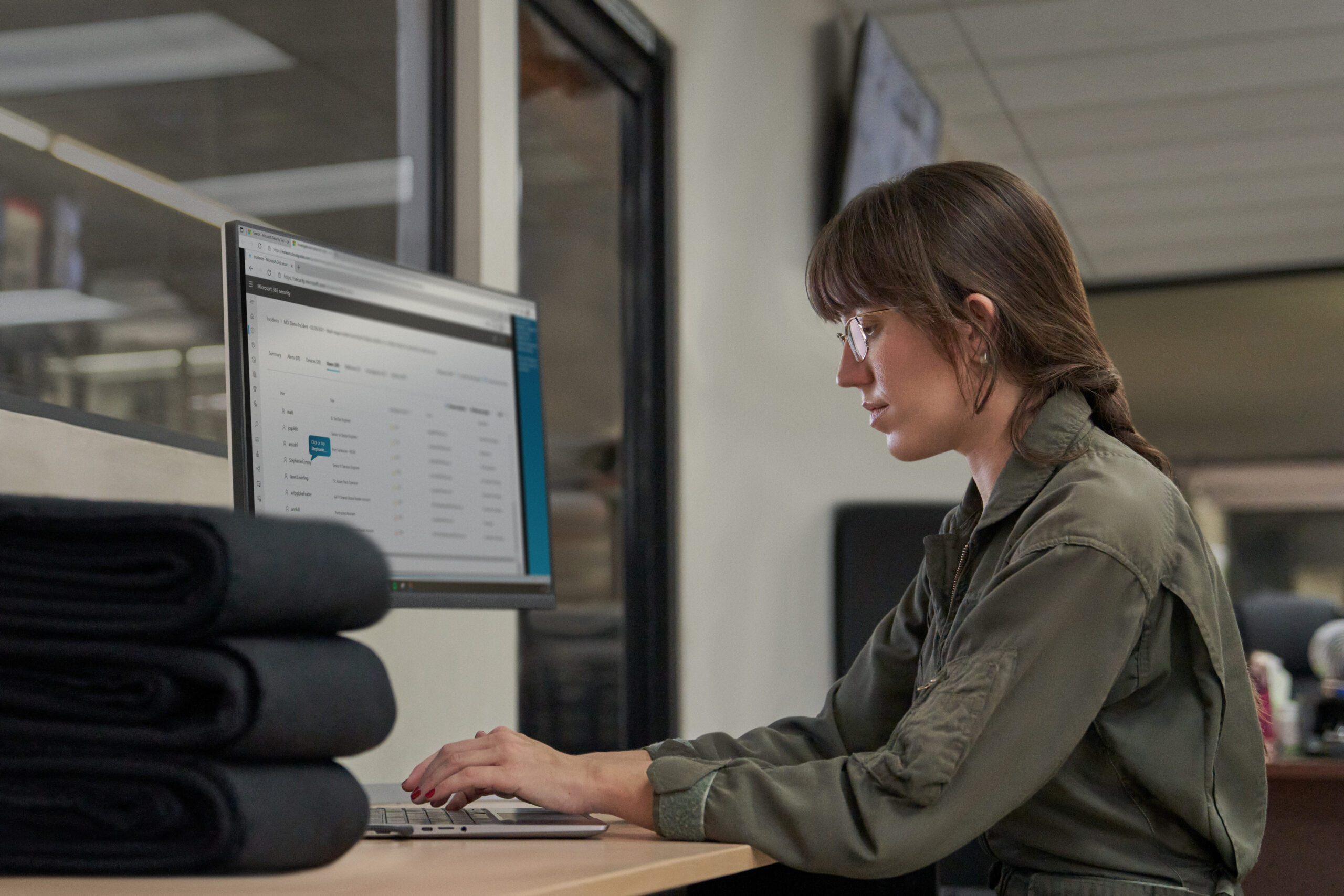 Photo of a technician working on a computer on a factory floor.