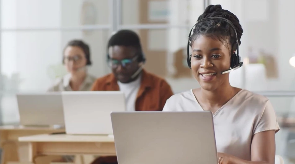 a person sitting at a table in front of a laptop