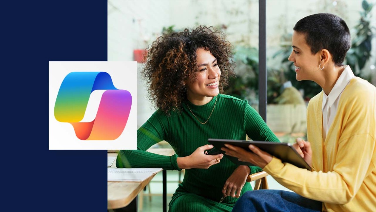 Two people look at each other smiling as one is holding a table. The copilot logo is overlaid on the left side of the image.