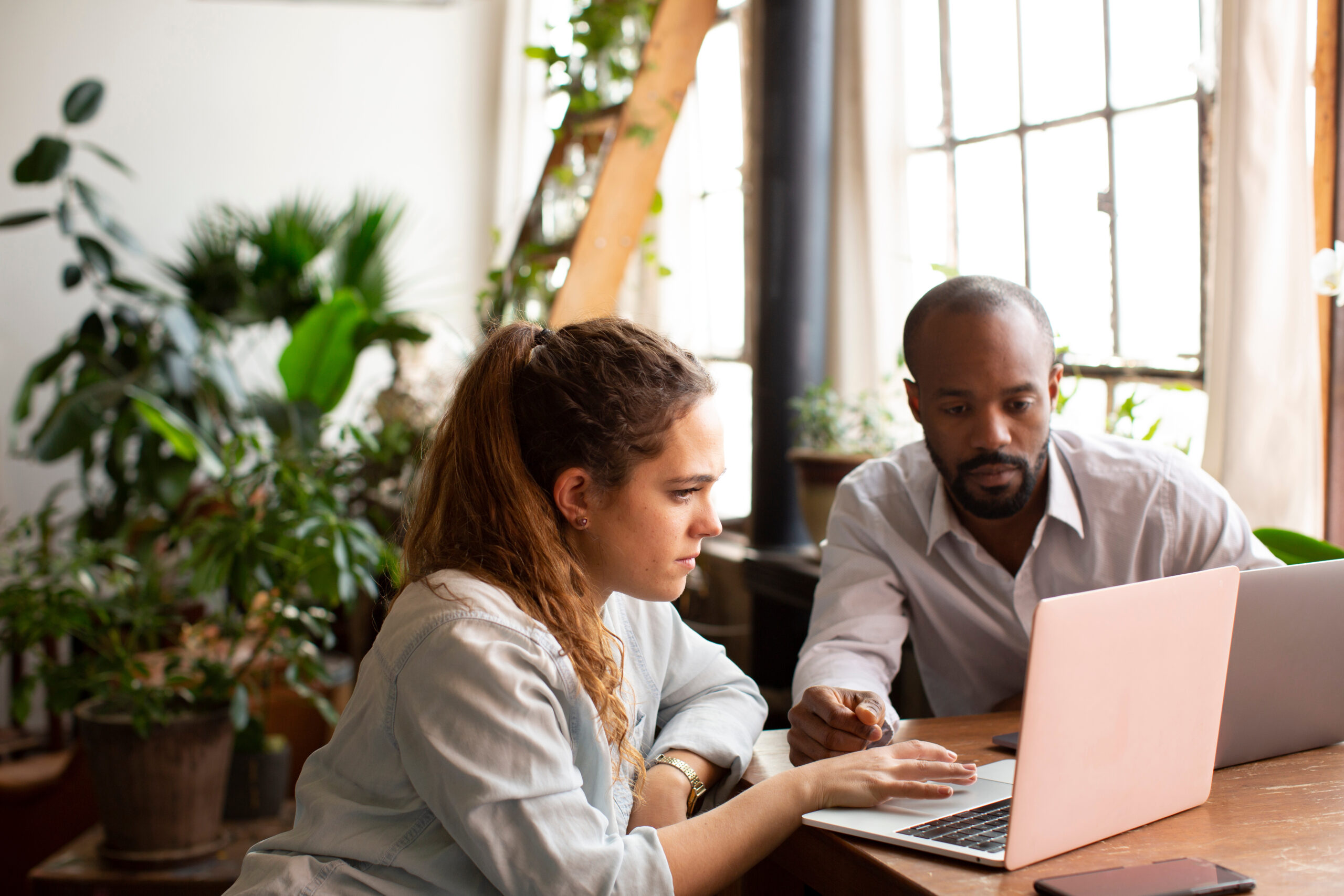A man and woman looking at a laptop