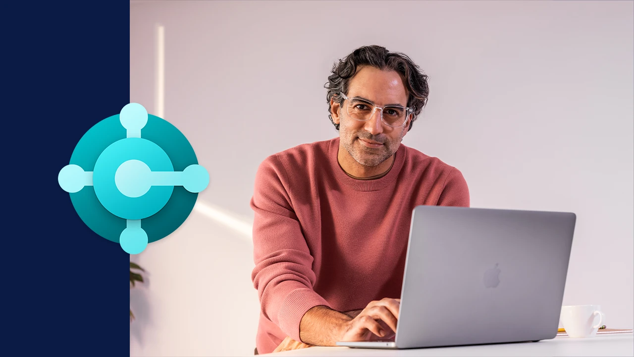 A man sitting at a desk with a laptop