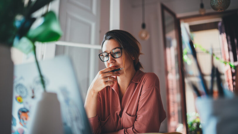 Young businesswoman thinking about something while sitting front