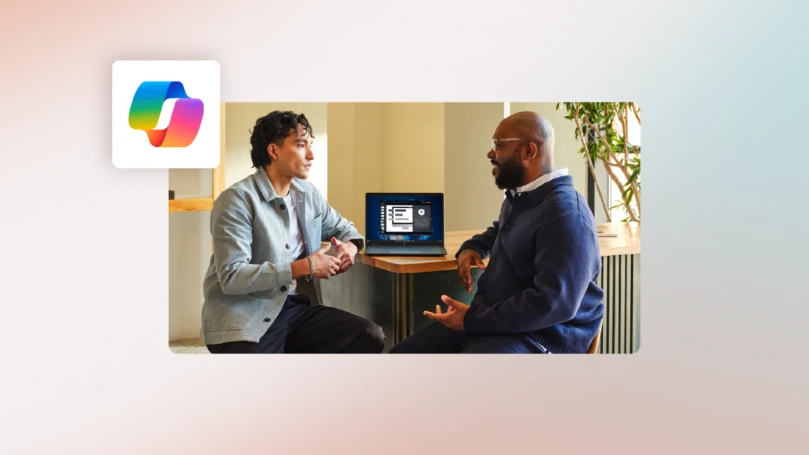 Two finance professionals sitting at a table talking