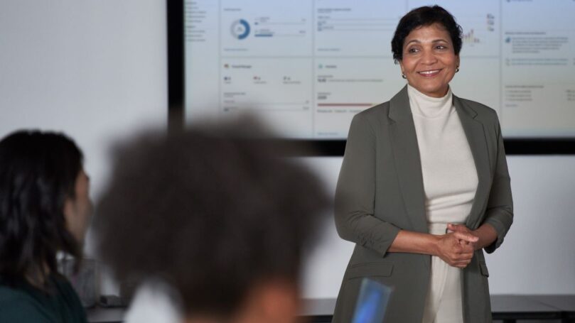 A woman presents information in a meeting.
