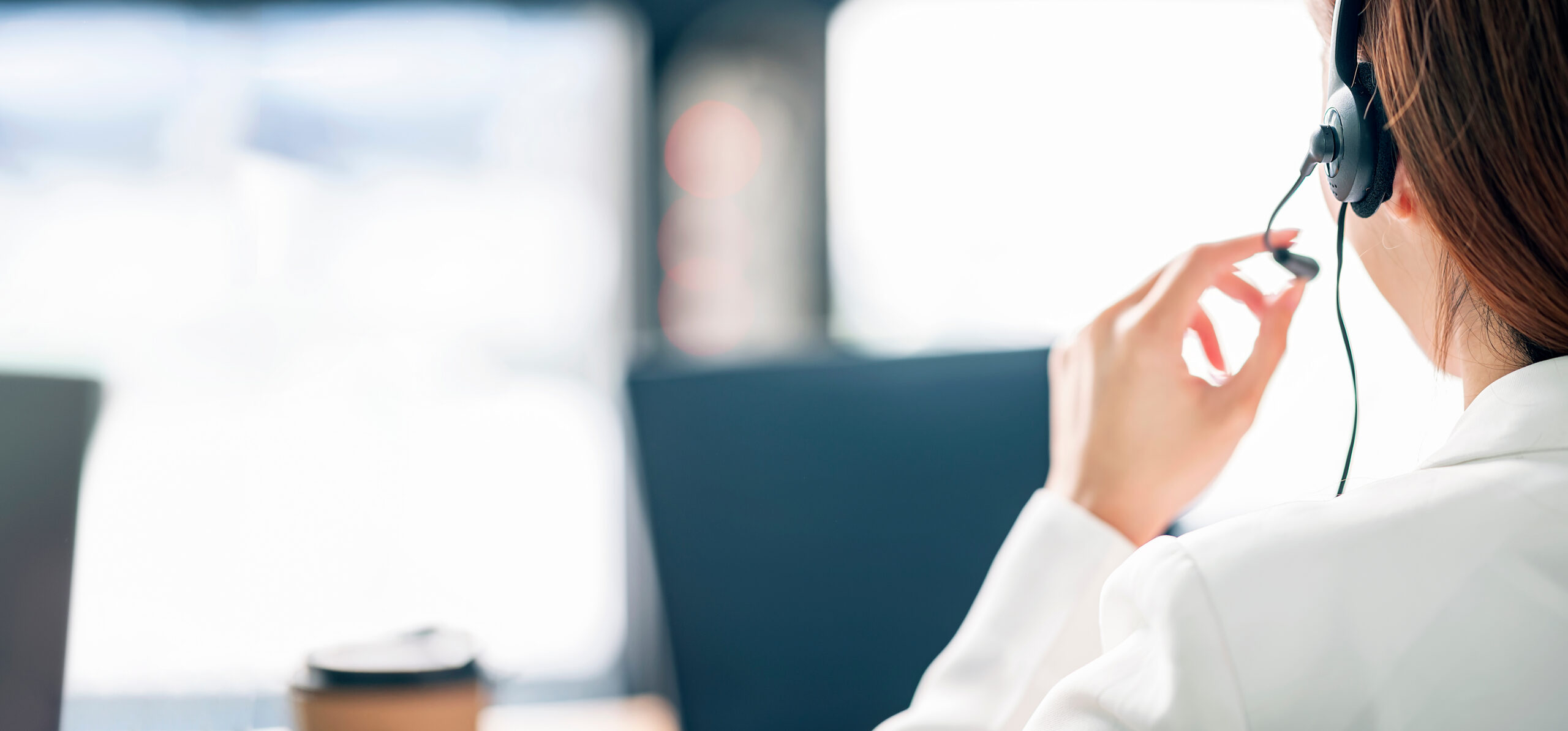 Call center help line service. Rear view of female operator in h