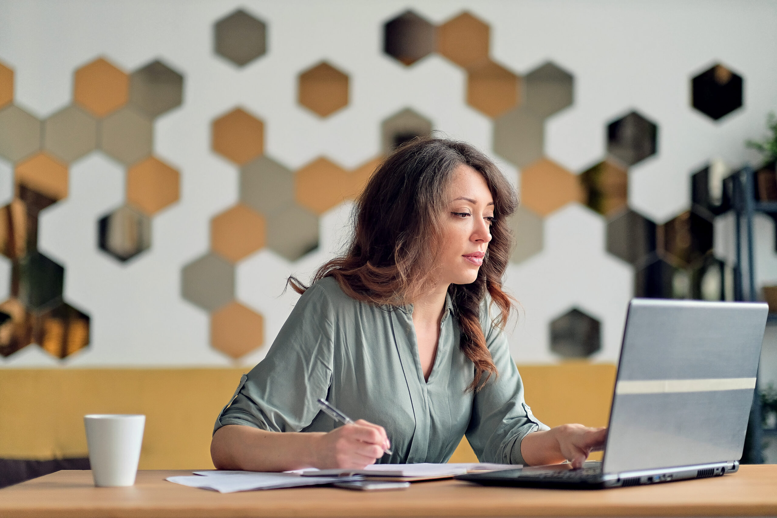 Young woman working from home office. Freelancer using laptop and the Internet. Workplace in living room
