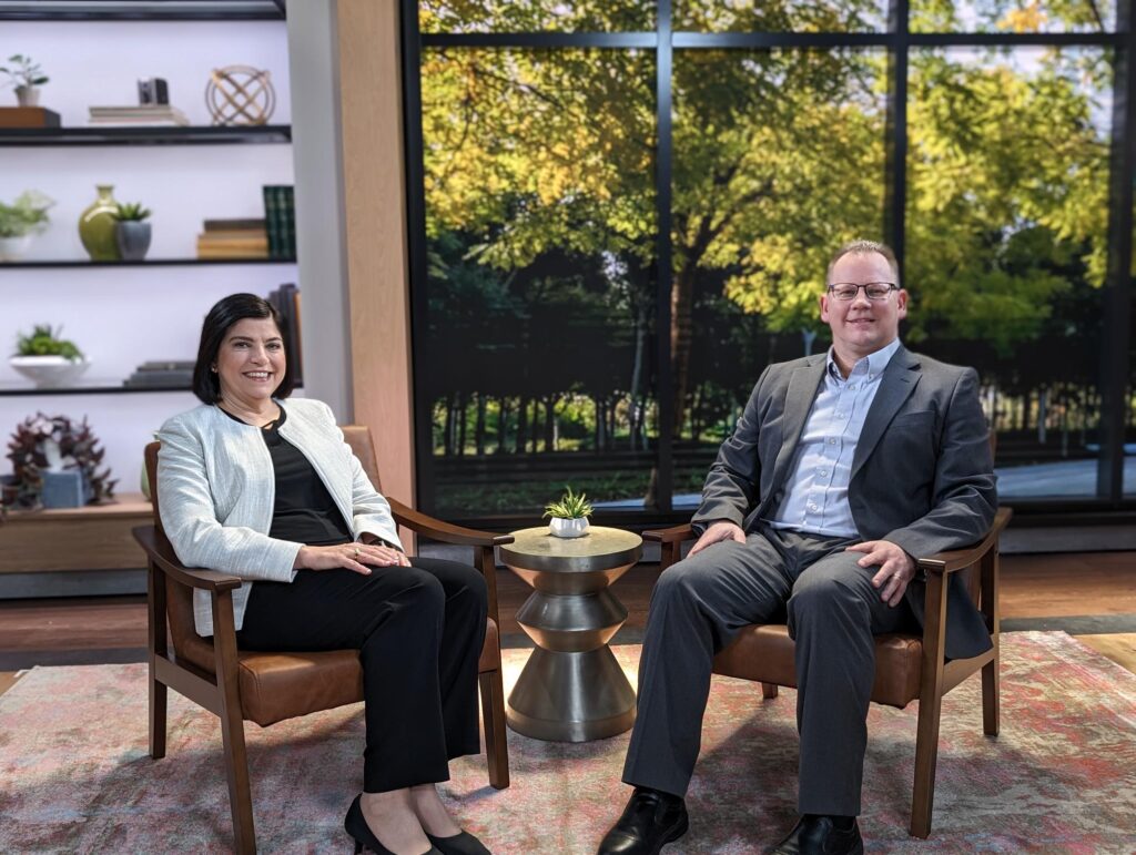 Paige Johnson and Chris Reykdal sitting together, engaged in conversation.