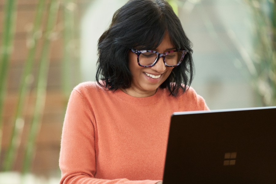 An educator works on a laptop.