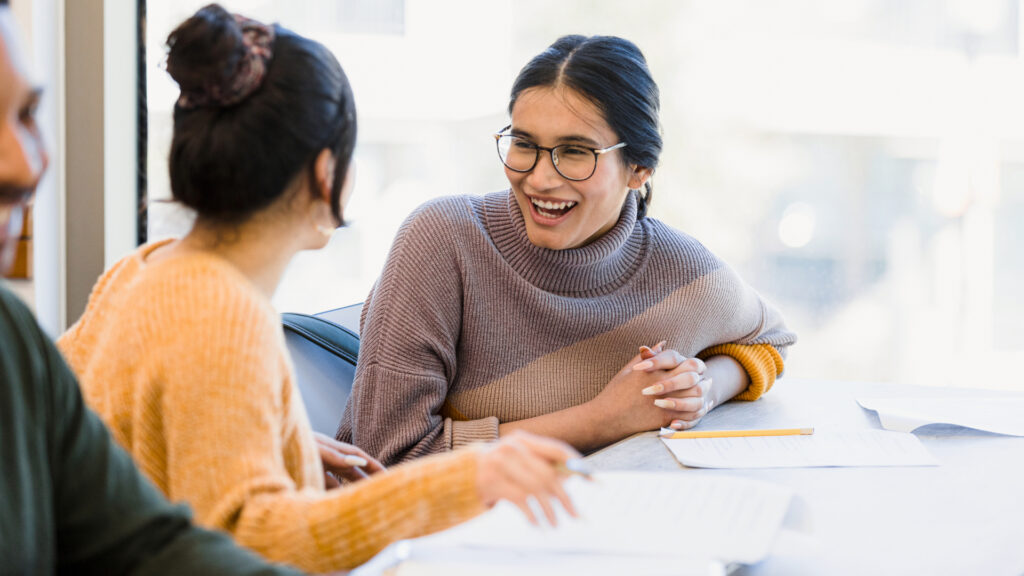 Two students collaborating and enjoying their work together.