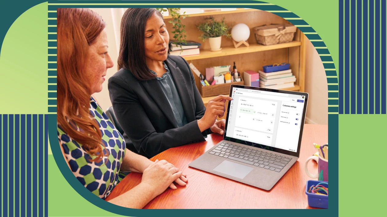 Two educators sitting together and reviewing a student’s Math Progress assignment