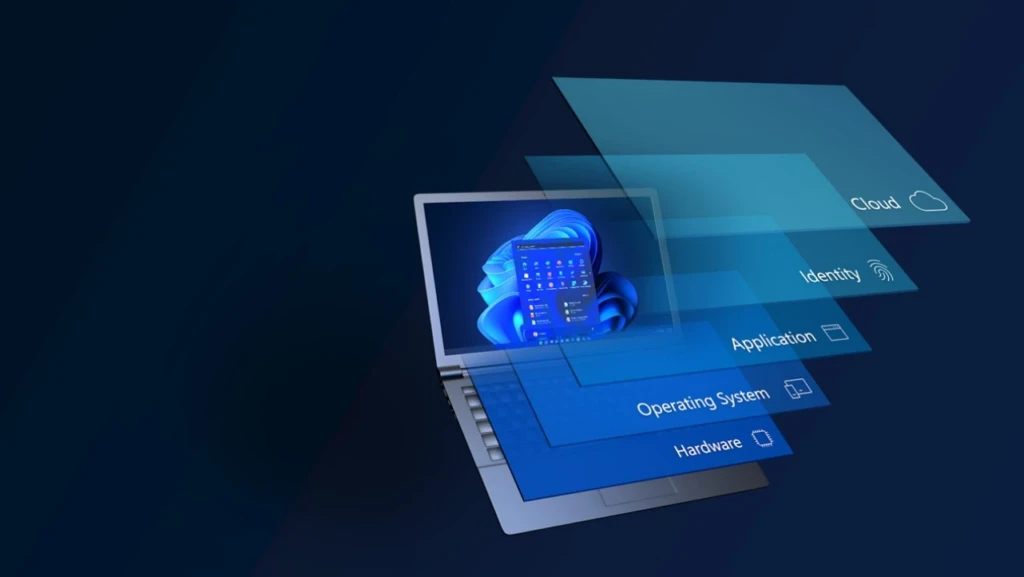 An open laptop shows the Windows 11 Start menu with abstract layers floating above the keyboard.