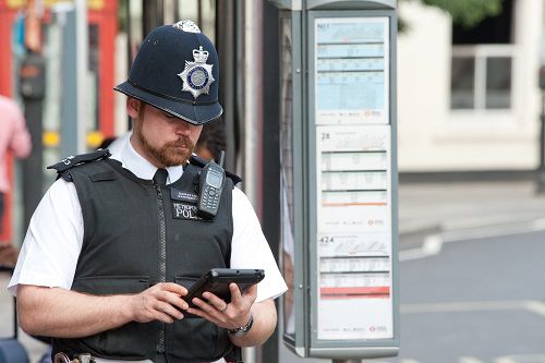 Picture of a police officer holding a tablet