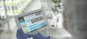 A health professional holding a tablet