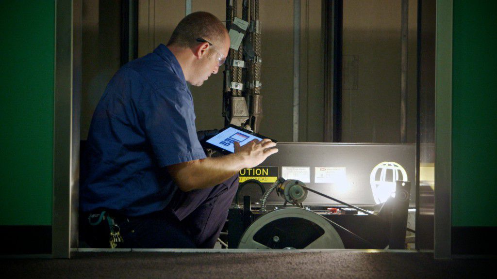 Image of a technician conducting a repair on a machine