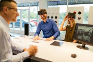 Couple using Virtual Reality glasses in a car dealership