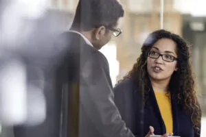 Man greeting woman to consult on investing