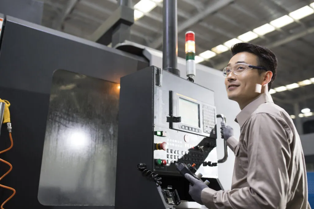 Confident engineer working in the factory