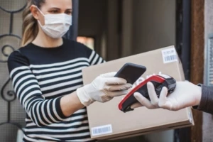 woman in mask accepting a package