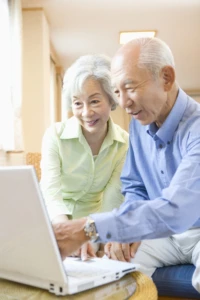 a group of people looking at a laptop