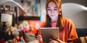 a person sitting at a table using a laptop computer