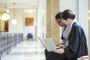 Female Judge and female lawyer examining documents together