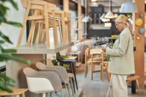 Retail store manager using a tablet to analyze floor and endcap data.