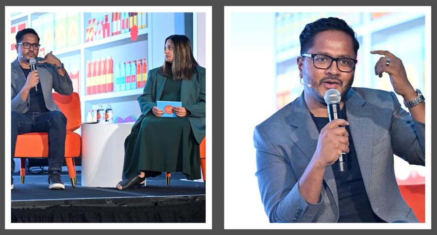 Satish Thomas sitting in a chair speaking.