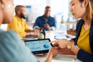 A woman pointing at a tablet