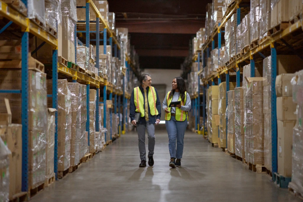 A group of manufacturing professionals walking in a factory